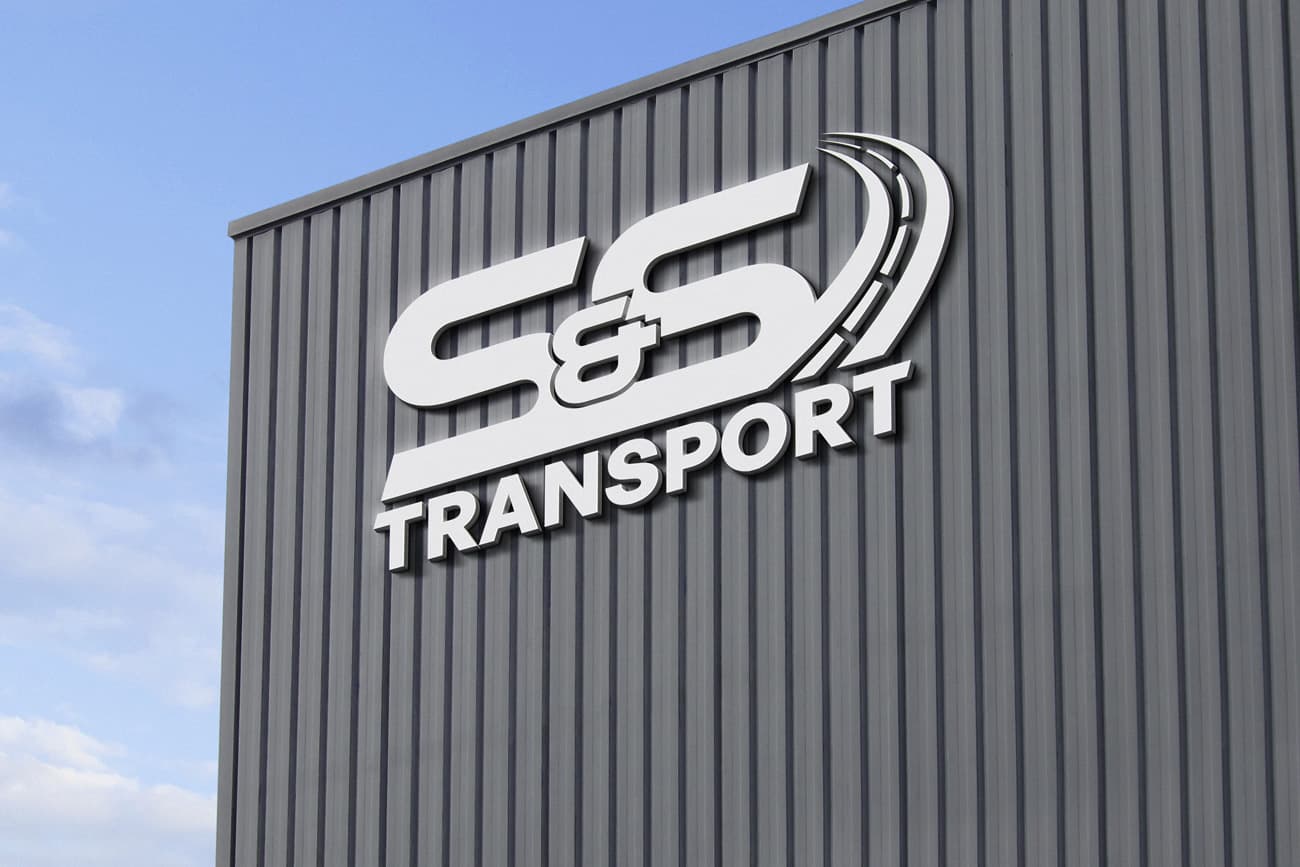 S and S Transport logo mounted on an industrial building facade